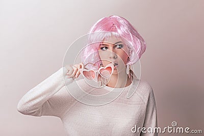 Portrait of teenage model with pink hair posing against pastel background Stock Photo