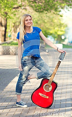 Portrait of a teenager with a guitar in the park Stock Photo