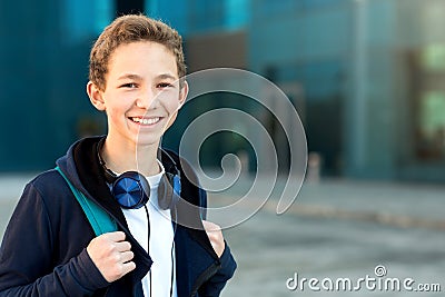 Portrait of a teenager with headphones and backpack outdoors. Copy space Stock Photo
