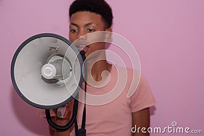 Portrait of teenager using a loudhailer shot up close Stock Photo