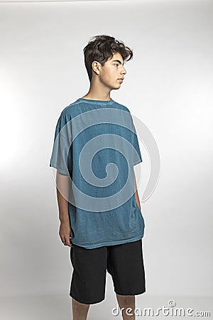 Portrait of teenager on white background in studio. The boy is standing Stock Photo