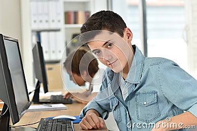 Portrait of teenager working on computer Stock Photo