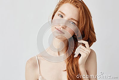 Portrait of tender beautiful girl with red hair smiling looking at camera. Stock Photo