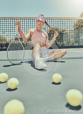 Portrait, tennis sports and woman on court with racket after workout, training or exercise. Fashion, fitness balls or Stock Photo
