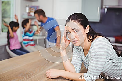 Portrait of tensed mother at table Stock Photo