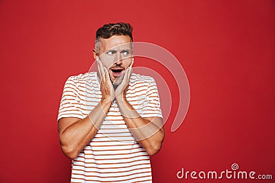 Portrait of terrified adult man grabbing his face in confusion o Stock Photo