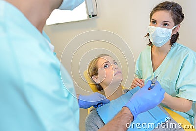 Portrait terrified woman scared at dentist Stock Photo