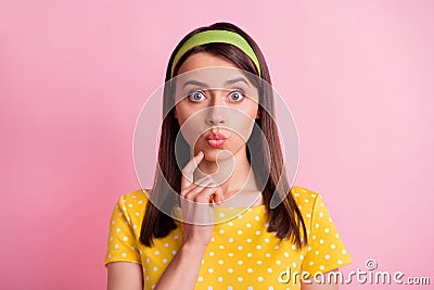 Portrait of thinking pretty brunette girl finger chin blow kiss wear yellow cloth isolated on pastel pink color Stock Photo