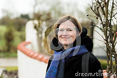 Portrait of a thirty year old beautiful woman with glasses at the Belgian countryside Stock Photo