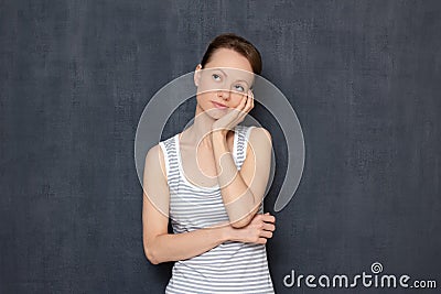 Portrait of thoughtful focused woman propping up head with hand Stock Photo