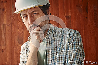 Portrait of thoughtful male worker with white protective helmet, employment and labor concept Stock Photo