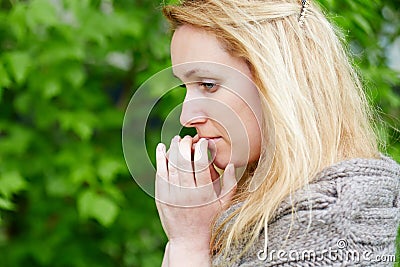 Portrait of thoughtful woman in hand-knitted jacket Stock Photo