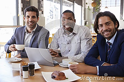 Portrait Of Three Businessmen Having Meeting In Coffee Shop Stock Photo