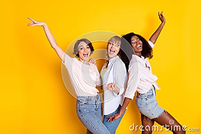 Portrait of three cheerful excited girls dark skin enjoy free time vacation disco isolated on yellow color background Stock Photo