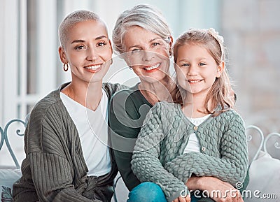 Portrait of three generations of females looking and smiling at the camera. Adorable little girl bonding with her mother Stock Photo