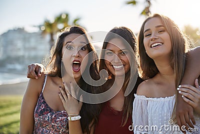 Three happy women standing together pulling faces Stock Photo