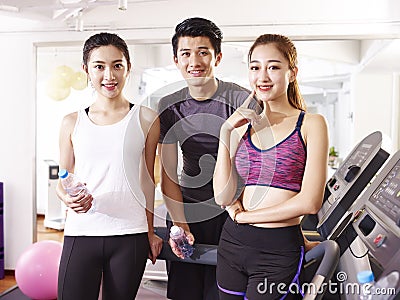 Portrait of three young asian people in gym Stock Photo