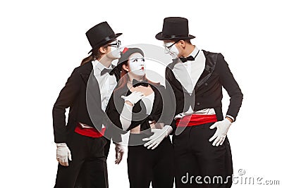 Portrait of three mime artists performing, isolated on white background. Man is telling interesting story, his Stock Photo