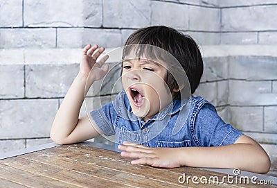Portrait tired child yawning, Little boy get a cold during weather change, Child having allergy. kid has reflection or hay fever Stock Photo