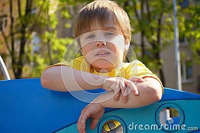 Portrait tired cute boy on the playground Stock Photo