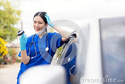 Portrait of tired exhausted nurse or doctor having a coffee break outside in the morning. COVID-19, Coronavirus pandemic Stock Photo