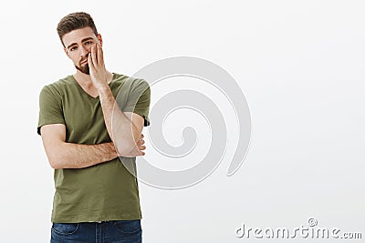 Portrait of tired and indifferent handsome boyfriend being brainwashed during argument facepalming looking exhausted and Stock Photo