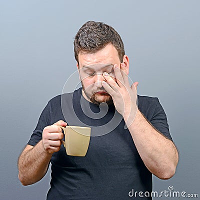 Portrait of tired man having first morning coffee and still sleepy Stock Photo