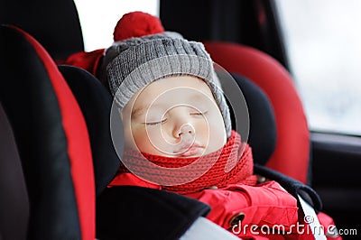 Portrait of toddler boy sleeping in car seat Stock Photo