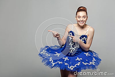 Portrait of toothy smiley beautiful ballerina woman in blue cost Stock Photo