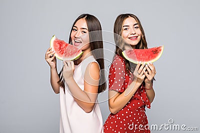 Portrait of tourists multiethnic ladies having lobes of watermelon in hands, isolated on white background Stock Photo