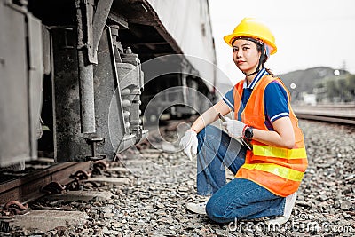 portrait train locomotive engineer women worker. Happy Asian young teen smiling work at train station train track locomotive Stock Photo