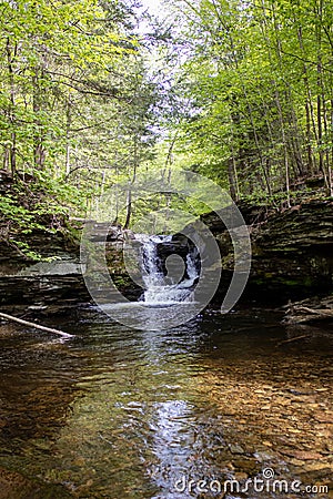 Portrait of Tranquility: A Vertical Shot of a Petite Pennsylvania Waterfall Stock Photo