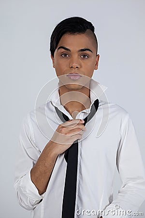 Portrait of transgender female holding tie Stock Photo