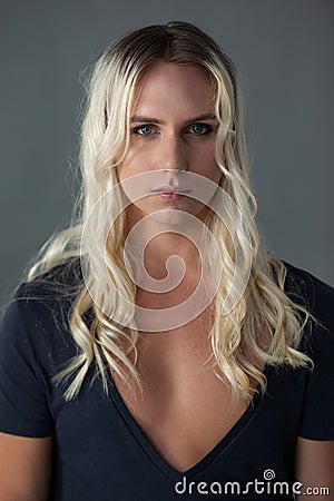 Portrait of transgender woman with long blond hair Stock Photo