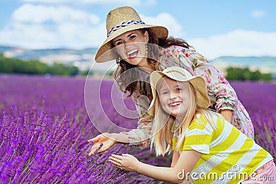 Mother and child against lavender field exploring lavender Stock Photo