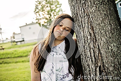 A Portrait of trisomie 21 adult girl outside at sunset Stock Photo