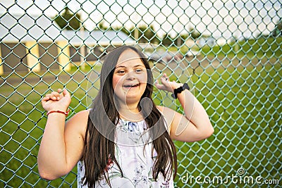 A Portrait of trisomie 21 adult girl outside at sunset Stock Photo