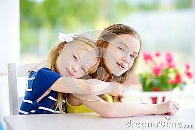 Portrait of two cute little sisters at home on beautiful summer day Stock Photo