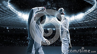 Portrait of two fencers against the backdrop of a sports arena. The concept of fencing. Duel Stock Photo