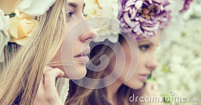 Portrait of the two gorgeous ladies with flowers Stock Photo