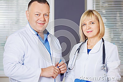 Portrait of two happy mature doctors. Stock Photo