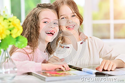 Girls reading magazine Stock Photo