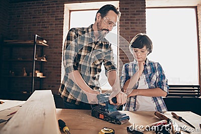 Portrait of two nice person concentrated focused woodworkers master artisan handyman dad daddy teaching son old Stock Photo