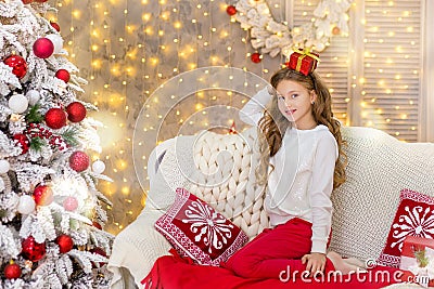 Portrait of two one young girls sisters close to white green Christmas tree. The girls in beautiful evening dresses clothes in New Stock Photo