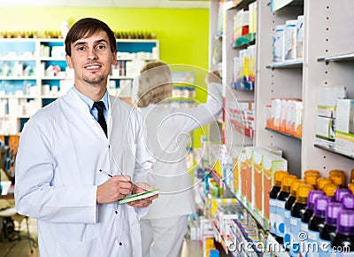 Portrait of two pharmacists working in modern farmacy Stock Photo