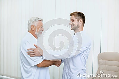 Portrait of two smiling specialist shaking hands. Stock Photo