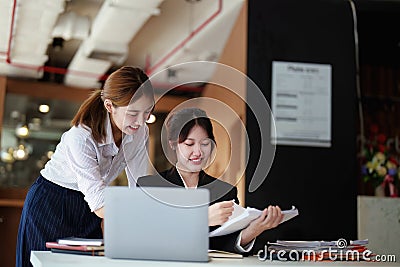 A portrait of two young Asian businesswoman plan marketing strategies and investments to profit from their clients Stock Photo