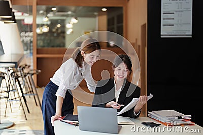 A portrait of two young Asian businesswoman plan marketing strategies and investments to profit from their clients Stock Photo