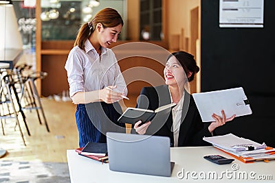 A portrait of two young Asian businesswoman plan marketing strategies and investments to profit from their clients Stock Photo