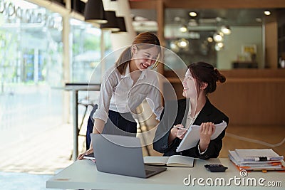 A portrait of two young Asian businesswoman plan marketing strategies and investments to profit from their clients Stock Photo